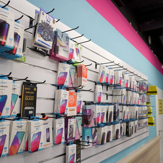 Regalwand mit verschiedenen Schutzfolien und Displayschutzprodukten bei Handy Hero